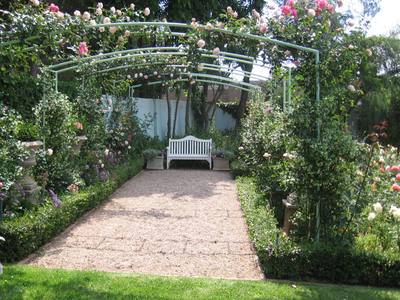 Garden design by Shirley Wallington — Arches covered in roses