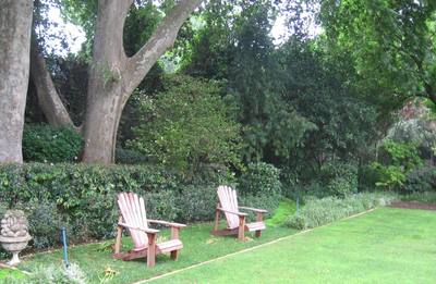 Garden design by Shirley Wallington — Chairs to create a focal point and look back at the house