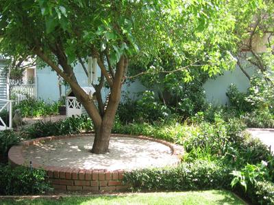 Garden design by Shirley Wallington — Create a circle around a tree with river sand or crushed stone