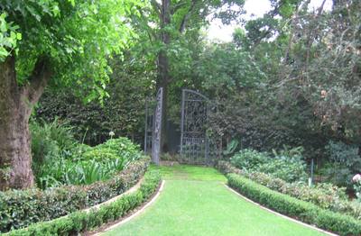 Garden design by Shirley Wallington — Re purposed gates found when installing the garden these were used to create the secret passage