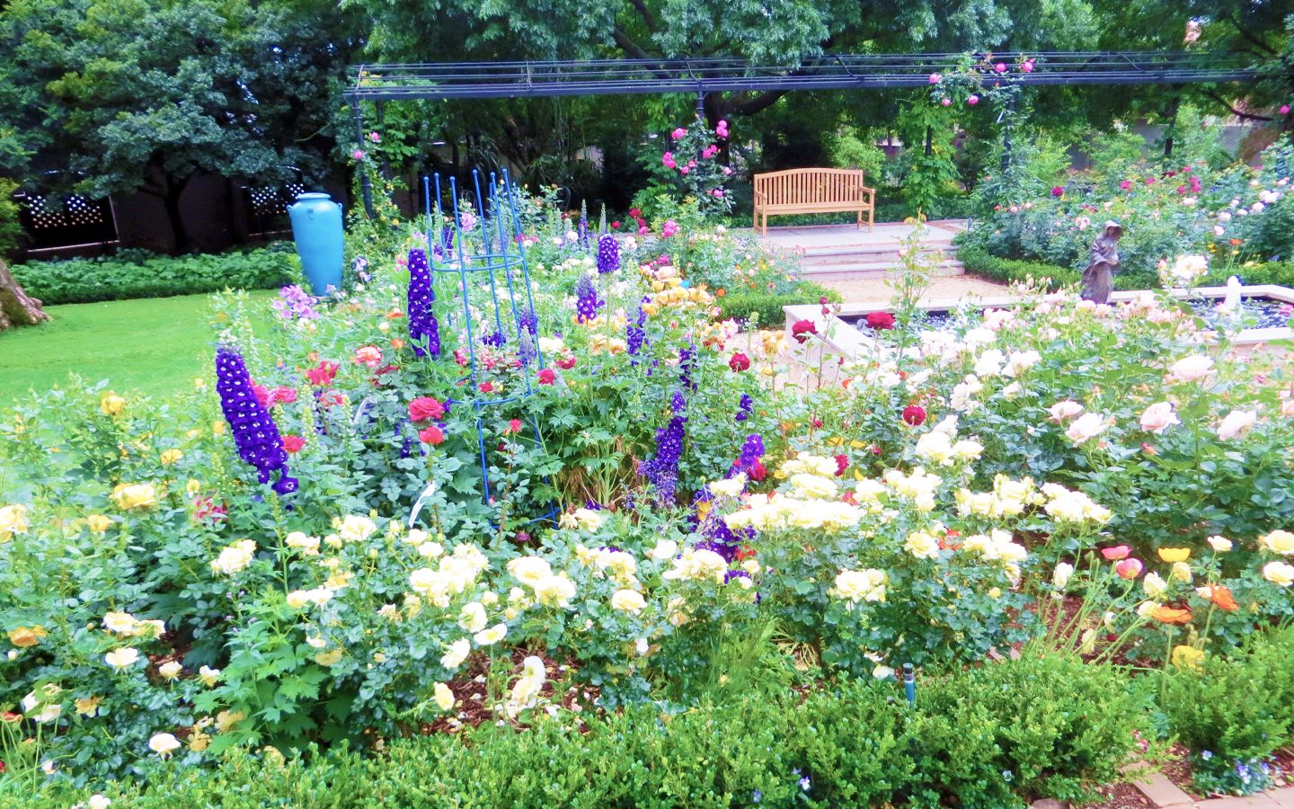 Garden walkway framed by rose-covered arches